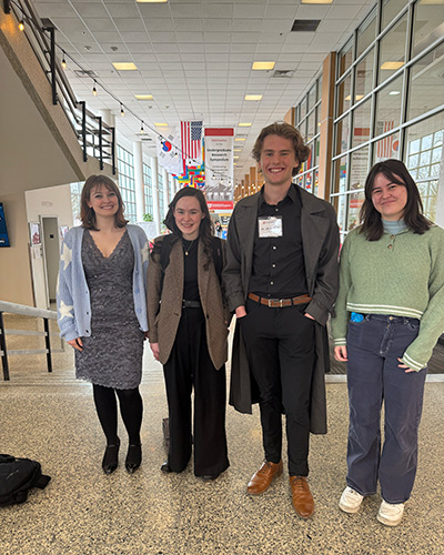 The 4 students that participated in the writing workshop standind as a group near the Union Ballroom